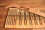Double slotted rigid heddle with 11 pattern strings - Harvest Looms
