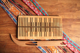 Double slotted rigid heddle with 11 pattern strings - Harvest Looms