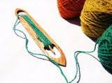 wood weaving shuttle with yarn wrapped for backstrap loom, off center