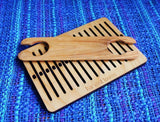 wooden loom kit with shuttle and heddle from left side angle