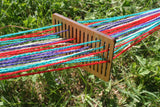 backstrap rigid heddle loom with yarn in use outside